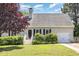 Charming single-story home with manicured lawn, trimmed bushes, and a one-car garage at 809 Maple Shade Ln, Apex, NC 27502