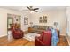 Open living room with hardwood floors, stylish furniture, and view into dining area at 809 Maple Shade Ln, Apex, NC 27502