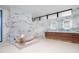 Luxurious bathroom with a standalone tub and dual vanity, accentuated by marble walls at 812 Stradella Rd, Raleigh, NC 27614