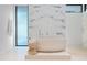 Elegant bathroom showcasing a freestanding tub and marble accent wall at 812 Stradella Rd, Raleigh, NC 27614