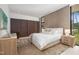 Bright bedroom featuring natural textures, a comfortable bed, and view of the outdoors at 812 Stradella Rd, Raleigh, NC 27614