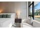 Comfortable bedroom with a cozy armchair, view of the outdoors and stylish décor at 812 Stradella Rd, Raleigh, NC 27614