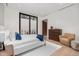 Sunlit bedroom offers a comfy bed, seating, wooden floors and views of the outdoor scenery at 812 Stradella Rd, Raleigh, NC 27614