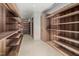 Spacious walk-in closet featuring custom wood shelving and ample storage space at 812 Stradella Rd, Raleigh, NC 27614