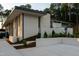 Contemporary home featuring clean lines, a stone accent wall, manicured landscaping and a flat roof design at 812 Stradella Rd, Raleigh, NC 27614