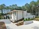 The exterior of this modern home features clean lines and landscaping, with a stone accent and concrete driveway at 812 Stradella Rd, Raleigh, NC 27614