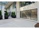 This garage features a modern, glass door and clean concrete driveway surrounded by potted plants and a modern exterior at 812 Stradella Rd, Raleigh, NC 27614