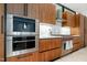 Elegant kitchen with stainless steel appliances, including a Wolf oven, and custom wood cabinetry at 812 Stradella Rd, Raleigh, NC 27614
