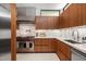 Kitchen features custom wood cabinets, marble countertops and backsplash, and stainless steel appliances at 812 Stradella Rd, Raleigh, NC 27614