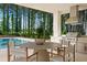 This home has a well appointed outdoor kitchen and dining area with a view of the beautiful pool and towering trees at 812 Stradella Rd, Raleigh, NC 27614