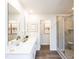 Bright, modern bathroom featuring double sinks, a glass-enclosed shower, and elegant decor with neutral colors at 817 Ottawa Dr, Garner, NC 27529