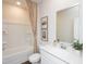 Well-lit bathroom with a clean white vanity, neutral walls, and a shower-tub combo with a patterned curtain at 817 Ottawa Dr, Garner, NC 27529