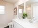 Bright bathroom featuring double sinks, neutral decor, and a large vanity mirror at 817 Ottawa Dr, Garner, NC 27529