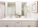 Stylish bathroom featuring double sinks with sleek white cabinets, modern fixtures, and elegant decor at 817 Ottawa Dr, Garner, NC 27529