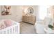 Adorable Bedroom featuring a crib, dresser, and accent chair, decorated with soft colors and bunny-themed decor at 817 Ottawa Dr, Garner, NC 27529