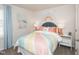 Cheerful bedroom with pastel colors, a striped bedspread, decorative pillows, and coordinating artwork at 817 Ottawa Dr, Garner, NC 27529
