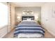 Cozy bedroom featuring a blue and white striped bedspread, natural light, and aviation-themed decor at 817 Ottawa Dr, Garner, NC 27529