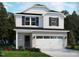 New two-story home featuring a brick foundation and white siding with black shutters and a two car garage at 817 Ottawa Dr, Garner, NC 27529