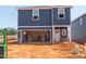 New two-story home featuring blue siding, unfinished yard, and an attached garage at 825 Ottawa Dr, Garner, NC 27529