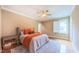 Relaxing bedroom features a ceiling fan, large window, and hardwood floors at 98102 Drummond, Chapel Hill, NC 27517