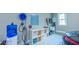 Garage showcasing an electric vehicle charger and storage shelves with baskets for organization at 98102 Drummond, Chapel Hill, NC 27517