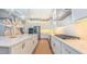 An open kitchen with an island, marble countertops and stainless steel appliances at 98102 Drummond, Chapel Hill, NC 27517