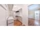 Well-organized walk-in closet provides ample storage with shelving and hanging space, leading to bathroom at 98102 Drummond, Chapel Hill, NC 27517