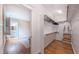 Walk-in closet with built-in shelves and rods, and doorway to the Primary bathroom and bedroom suite at 98102 Drummond, Chapel Hill, NC 27517