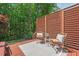 Cozy outdoor seating area with privacy screens surrounded by lush greenery at 1008 Justice Walk Ave, Morrisville, NC 27560
