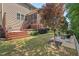 Private backyard offers multiple seating areas, lush landscaping, and a cozy firepit at 1008 Justice Walk Ave, Morrisville, NC 27560