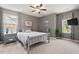 Comfortable bedroom with carpet, stylish gray walls, a ceiling fan, and natural lighting at 1008 Justice Walk Ave, Morrisville, NC 27560