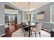 The dining room features large windows, a modern light fixture, and access to other rooms at 1008 Justice Walk Ave, Morrisville, NC 27560