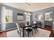 The dining room has a modern light fixture, large windows, and an open floor plan at 1008 Justice Walk Ave, Morrisville, NC 27560