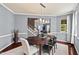 The dining room has a modern light fixture and view of the home's stairway at 1008 Justice Walk Ave, Morrisville, NC 27560