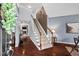Grand foyer with hardwood floors, staircase, and view into living room at 1008 Justice Walk Ave, Morrisville, NC 27560