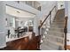 Spacious foyer with hardwood floors, a staircase, and views of the dining room and kitchen at 1008 Justice Walk Ave, Morrisville, NC 27560