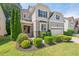 Two-story home with stone and siding exterior, a manicured lawn, and a two-car garage at 1008 Justice Walk Ave, Morrisville, NC 27560