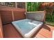 Close up of a luxurious hot tub with an open lid and a lush backyard view at 1008 Justice Walk Ave, Morrisville, NC 27560