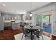 Grey kitchen boasts stainless appliances, an island, and opens to a screened porch with outdoor seating at 1008 Justice Walk Ave, Morrisville, NC 27560