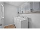 Functional laundry room features white cabinets and washer and dryer units at 1008 Justice Walk Ave, Morrisville, NC 27560