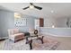Second-floor living area featuring plush furniture, neutral walls, and a glass coffee table at 1008 Justice Walk Ave, Morrisville, NC 27560
