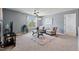 Bright living room features neutral walls, plush carpet, large windows, and stylish furniture at 1008 Justice Walk Ave, Morrisville, NC 27560