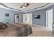 Large main bedroom boasting plush carpet, a ceiling fan, and convenient access to other rooms at 1008 Justice Walk Ave, Morrisville, NC 27560