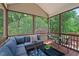 Relaxing screened porch with comfortable seating and a view of the lush greenery at 1008 Justice Walk Ave, Morrisville, NC 27560