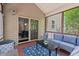 Inviting screened porch with blue outdoor furniture and views into the kitchen at 1008 Justice Walk Ave, Morrisville, NC 27560
