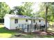 Charming backyard with mature trees and well-maintained landscaping on a sunny day at 10180 Buffalo Rd, Clayton, NC 27527