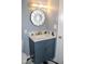 Stylish bathroom with marble countertops, blue vanity, new fixtures and decorative mirror at 10180 Buffalo Rd, Clayton, NC 27527