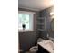 Renovated bathroom with a marble countertop, gray walls, storage and natural light from a window at 10180 Buffalo Rd, Clayton, NC 27527