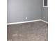 Neutral carpeted room featuring light gray walls and a small window at 10180 Buffalo Rd, Clayton, NC 27527