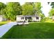 View of the house with a well-maintained lawn and a long driveway leading up to it at 10180 Buffalo Rd, Clayton, NC 27527